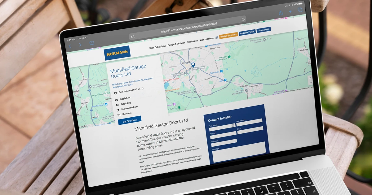Laptop displaying the Hörmann Truedor Installer Finder webpage showing a map and contact details for Mansfield Garage Doors Ltd