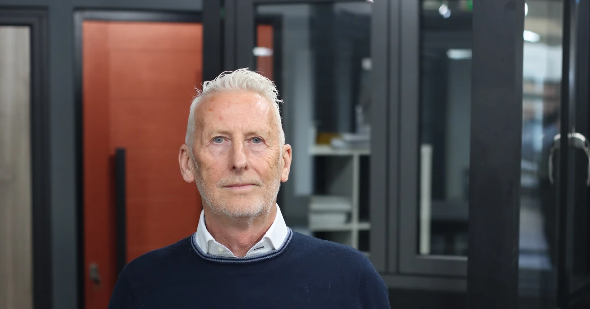 Keith White, Managing Director and owner of aluplast UK, standing indoors with windows and doors in the background