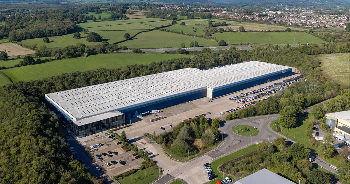 Aerial view of AluK's large factory and headquarters building in a rural setting near Chepstow