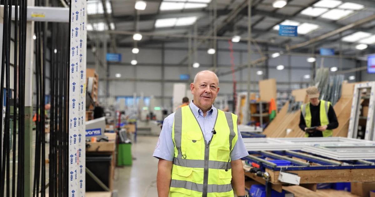 Mark Smith in a high-visibility vest standing inside the Glazerite manufacturing facility.