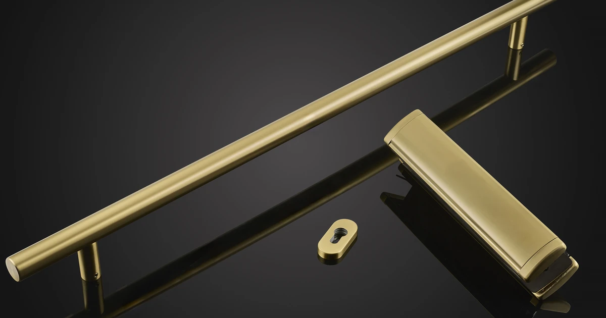 Satin gold bar handle, letterplate and escutcheon displayed on a black reflective background